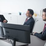 elderly men sitting while talking to each other