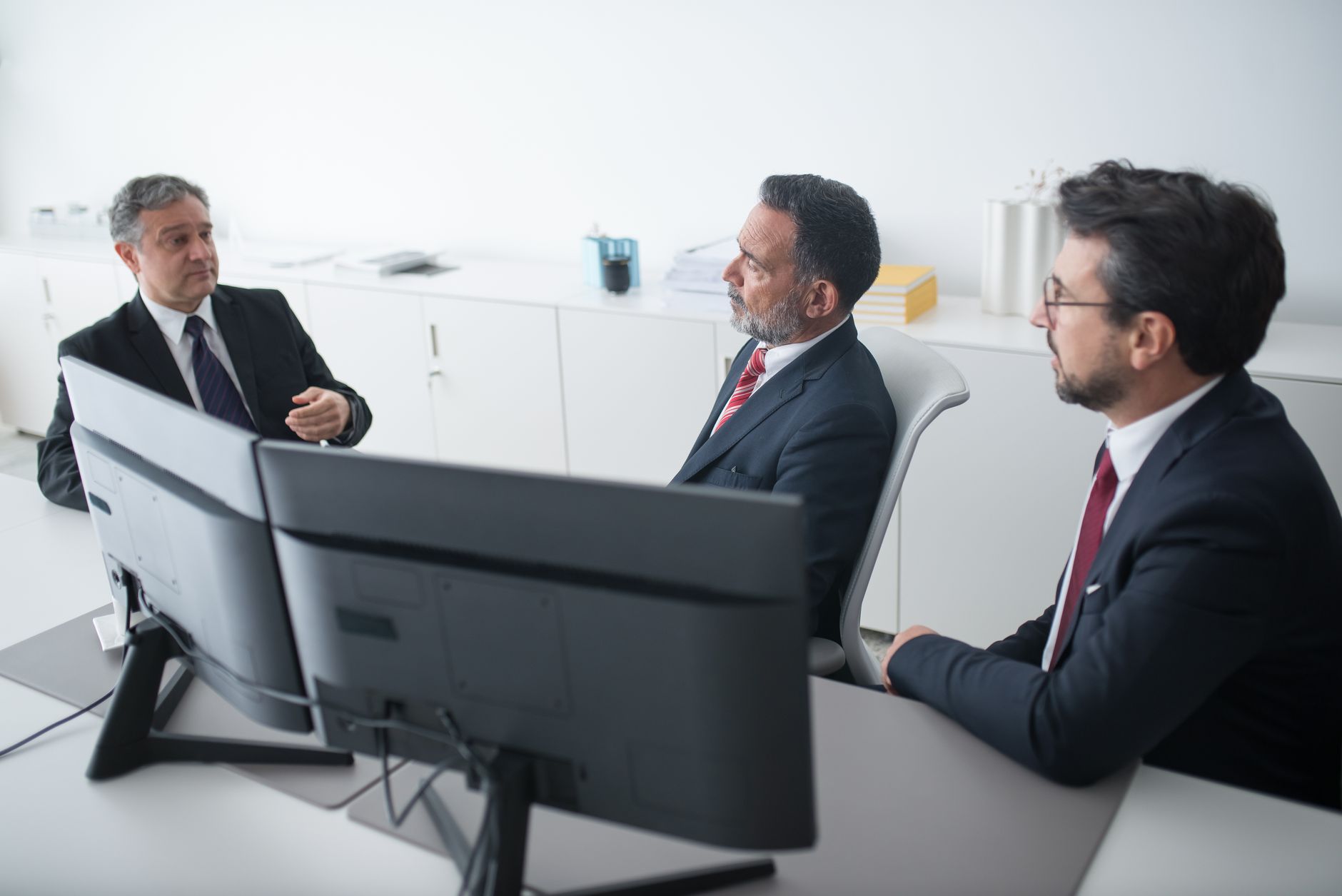 elderly men sitting while talking to each other